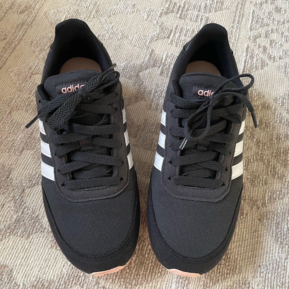 Cute, pink soles, black adidas sneakers. Only worn once.